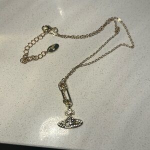 Gold viv Westwood necklaces with safety pin